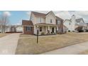 Attractive two-story home with a brick and siding exterior, complemented by a well-kept lawn and landscaping at 17953 Forreston Oak Dr, Noblesville, IN 46062