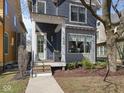 Home exterior showcases a lovely front porch and tasteful landscaping at 1838 Alabama St, Indianapolis, IN 46202