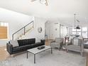 Open-concept living area with modern furnishings, hardwood floors, and staircase at 1838 Alabama St, Indianapolis, IN 46202