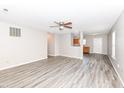 Bright living room featuring neutral walls, and durable wood-look flooring at 3026 Everbloom Way, Indianapolis, IN 46217