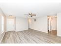 Open living room with grey wood-look floors, neutral paint and ample natural light at 3026 Everbloom Way, Indianapolis, IN 46217