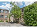 Attractive brick townhome with red shutters, featuring a stairway and lush greenery at 3052 Skylar Ln, Indianapolis, IN 46208