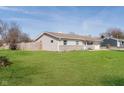 This cozy home features vinyl siding, a fenced yard, and a well-maintained lawn at 348 W Stop 11 Rd, Indianapolis, IN 46217