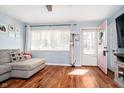 Cozy living room featuring hardwood floors, a comfortable sofa, and natural light streaming through the windows at 348 W Stop 11 Rd, Indianapolis, IN 46217