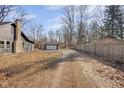 Large backyard featuring a detached garage and wooden privacy fence at 3905 N Drexel Ave, Indianapolis, IN 46226