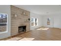Bright living room with light wood floors and a stone fireplace at 3905 N Drexel Ave, Indianapolis, IN 46226