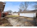 Large backyard with a detached two-car garage and concrete driveway, offering ample outdoor space at 4013 Priscilla Ave, Indianapolis, IN 46226