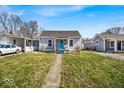 Inviting single-story home with a well-kept lawn and a bright blue front door at 4529 Norwaldo Ave, Indianapolis, IN 46205