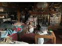 A crowded living room filled with furniture, books, and various decorative items on shelves and surfaces at 4718 W 36Th St, Indianapolis, IN 46222