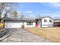 Charming one-story home with driveway leading to attached garage and well-maintained lawn at 5118 E 69Th St, Indianapolis, IN 46220