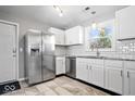 Modern kitchen features stainless steel appliances, white cabinets, and stylish tile flooring at 5118 E 69Th St, Indianapolis, IN 46220