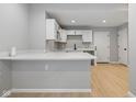 Bright kitchen featuring white cabinets and countertops and stainless steel hardware at 516 N Chester Ave, Indianapolis, IN 46201