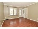 Cozy living room with wood-look flooring and natural light, near the front door at 5909 Furnas Rd, Indianapolis, IN 46221