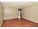 Bright living room featuring wood-look flooring, neutral walls and a sliding glass door at 5909 Furnas Rd, Indianapolis, IN 46221