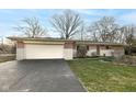 Charming brick ranch home with attached garage, and well-manicured lawn at 6914 Honnen W Dr, Indianapolis, IN 46256