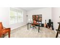 Neutral bedroom with a large window, carpeted floors, and home office setup at 698 Ridge Gate Dr, Brownsburg, IN 46112
