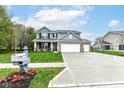 Beautifully landscaped two-story home with a spacious driveway and three-car garage at 698 Ridge Gate Dr, Brownsburg, IN 46112
