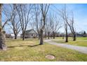 Spacious lot featuring a cozy home, detached garage, and a long gravel driveway at 712 N Pendleton Ave, Pendleton, IN 46064