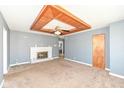 Inviting living room with brick fireplace, decorative wood ceiling and neutral carpet at 7401 E 56Th St, Indianapolis, IN 46226