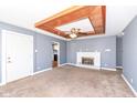 Cozy living room featuring a fireplace, ceiling fan, and wood-trimmed ceiling at 7401 E 56Th St, Indianapolis, IN 46226