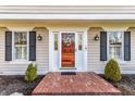 Close-up of the home's front entrance, showcasing a decorative wreath, sidelight windows, and brick entryway at 804 Bennett Ct, Carmel, IN 46032