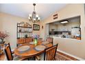 Inviting dining room featuring a wooden table, elegant chandelier, and decorative furnishings for Gathering gatherings at 9235 Doubloon Rd, Indianapolis, IN 46268