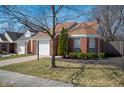 Attractive exterior of a brick home with a tidy lawn and an attached garage at 9550 Colony Pointe E Dr, Indianapolis, IN 46250