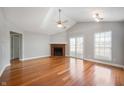 Inviting living room with vaulted ceiling, ceiling fan, fireplace, and wood floors at 9550 Colony Pointe E Dr, Indianapolis, IN 46250