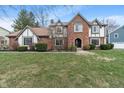 Two-story home with brick and siding, lush lawn, and nicely trimmed shrubs at 12715 Charing Cross Rd, Carmel, IN 46033