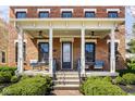 Welcoming front porch with comfortable seating, a brick facade, and elegant architectural details at 13018 Deerstyne Green St, Carmel, IN 46032