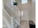 Spacious entryway featuring a staircase, wood-look floors, and a bright window over the front door at 1471 Pencross Ln, Greenwood, IN 46143