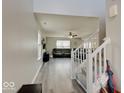 Inviting entryway with gray walls, wood-look floors, and a staircase leading to the upper level at 1471 Pencross Ln, Greenwood, IN 46143