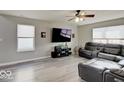 Comfortable living room with gray walls, wood-look floors, and a large sectional sofa at 1471 Pencross Ln, Greenwood, IN 46143