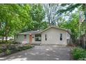 A well-maintained ranch home featuring a peach-colored front door and a landscaped front yard at 1740 Haynes Ave, Indianapolis, IN 46240