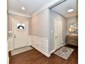 Elegant entryway featuring wainscoting, hardwood floors, and a decorative rug, leading to other rooms at 2186 Chick Evans Way, Westfield, IN 46074