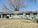 Charming ranch-style home featuring a cozy facade, attached garage, and well-maintained lawn at 2308 W Surrey Dr, Muncie, IN 47304