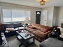 Cozy living room featuring a light fixture, front door, and lots of windows at 2308 W Surrey Dr, Muncie, IN 47304