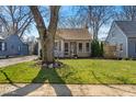 Single-story home featuring a beautiful lawn and mature tree in a serene neighborhood at 2603 E 58Th St, Indianapolis, IN 46220