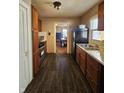 Functional kitchen with dark cabinets, ample counter space, stainless steel stove, and access to the dining area at 2940 Mckinley St, Anderson, IN 46016