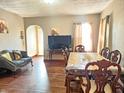 Bright living room featuring hardwood floors, large table, and a comfortable seating area at 2940 Mckinley St, Anderson, IN 46016