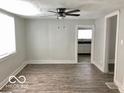 Inviting living room showcases updated floors and neutral walls, with an open doorway to the kitchen at 302 S Randolph St, Indianapolis, IN 46201