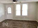 Bright living room featuring durable laminate flooring, updated fixtures, and ample natural light at 302 S Randolph St, Indianapolis, IN 46201