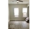 Living room featuring durable flooring, complemented by abundant natural light and convenient access to stairs at 302 S Randolph St, Indianapolis, IN 46201
