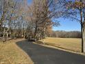 Long driveway lined with trees leading to a scenic property with open field at 3040 Old Morgantown Rd, Martinsville, IN 46151