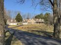 Beautiful home with an attached garage and a long driveway surrounded by lush trees at 3040 Old Morgantown Rd, Martinsville, IN 46151