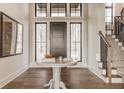 Welcoming foyer with hardwood floors and a staircase with wood and iron railing at 3787 Cherwell Dr, Zionsville, IN 46077