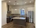 Bright kitchen with stainless steel appliances, granite countertops, and large central island at 477 Mariposa Trl, Carmel, IN 46032