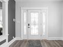 Elegant foyer with a decorative glass front door and neutral color palette, creating a welcoming entrance at 5602 N College Ave, Indianapolis, IN 46220