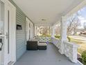 Spacious front porch with outdoor seating area, featuring classic architectural details and a relaxing ambiance at 5602 N College Ave, Indianapolis, IN 46220