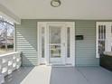 View of covered front porch with classic white railings and decorative pillars, providing an inviting outdoor space at 5602 N College Ave, Indianapolis, IN 46220